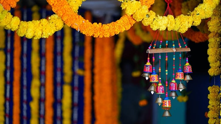 Image: Orange and yellow flower garlands hanging in the background and foreground, accompanied by a small wind chime. ",https://dev-ever-widening-circles.pantheonsite.io/wp-content/uploads/2021/10/joshuva-daniel-U4OS-GimdXA-unsplash-scaled-e1634745308956.jpg,,Culture