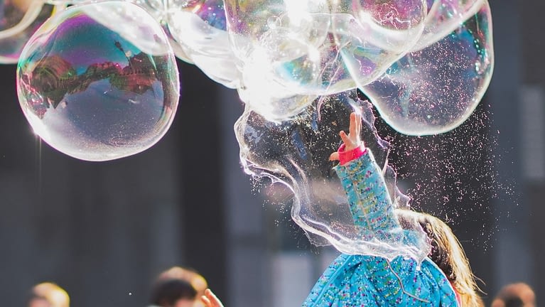 Image: A girl bursting a big bubble, indicative of growth