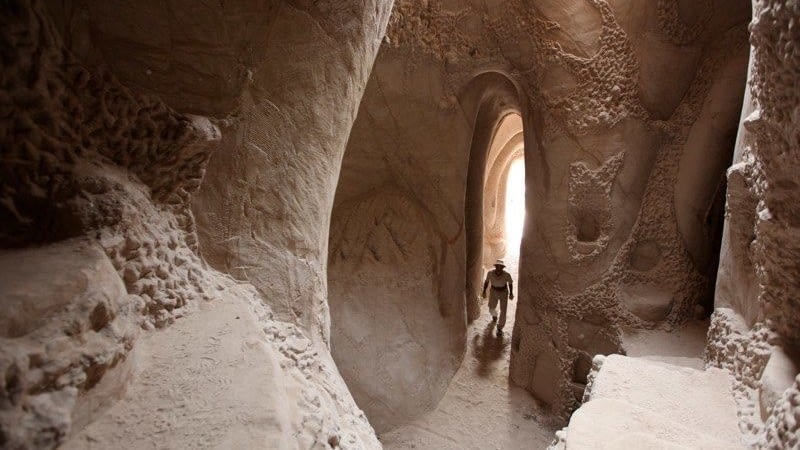 Image: "Caveman" Ra Paulette walking through one of his caves