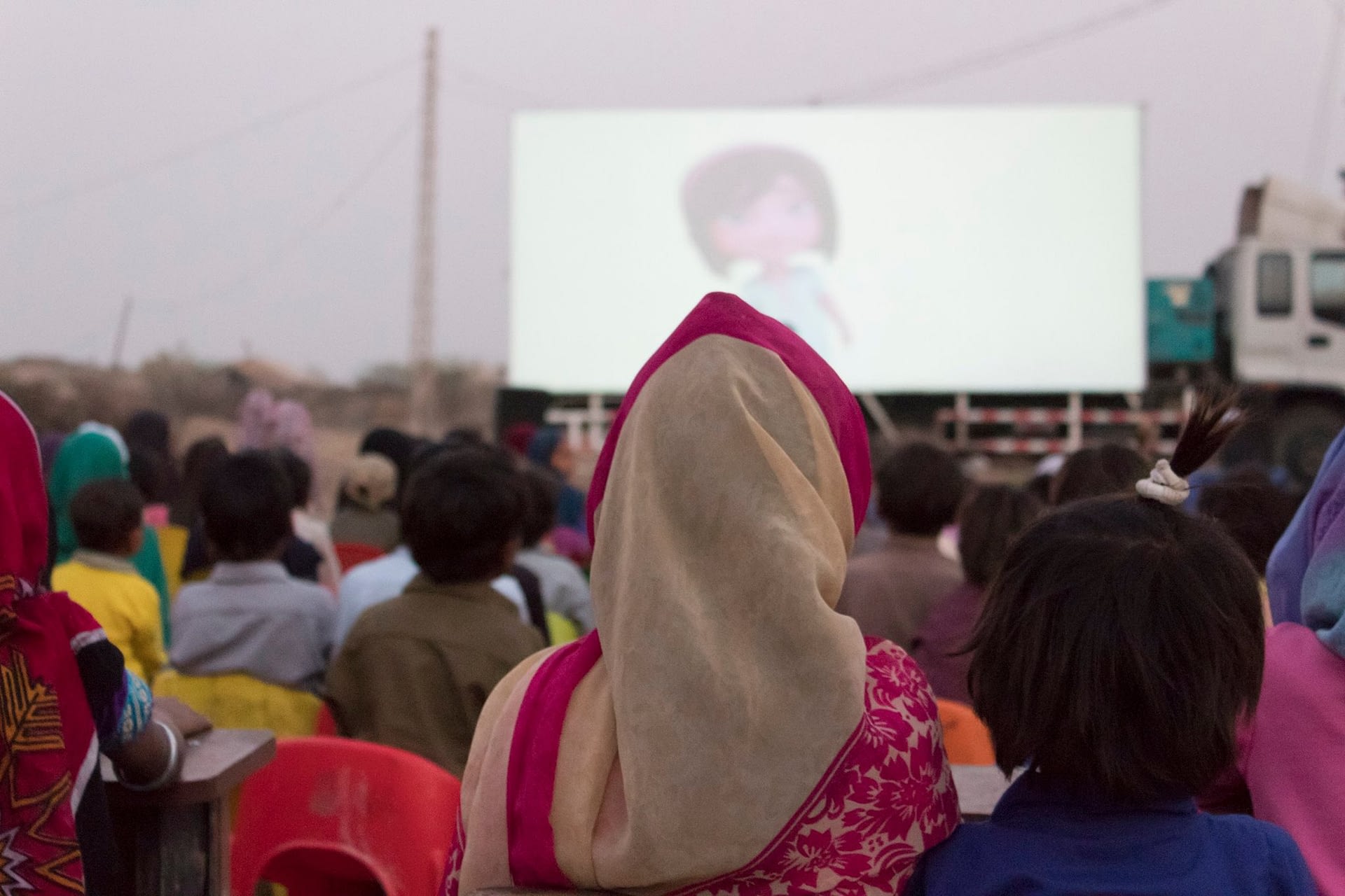 Image: People watching movie on mobile cinema, the project of Sharmeen Obaid-Chinoy