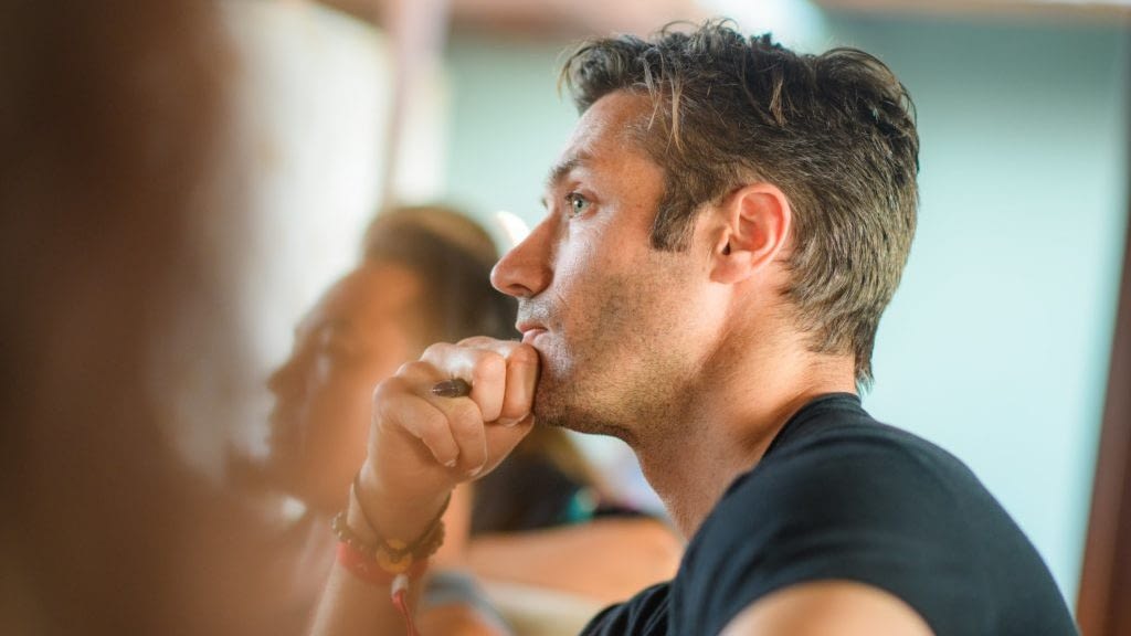 Image: Man in class with hand on chin, thinking. free your mind from fear.